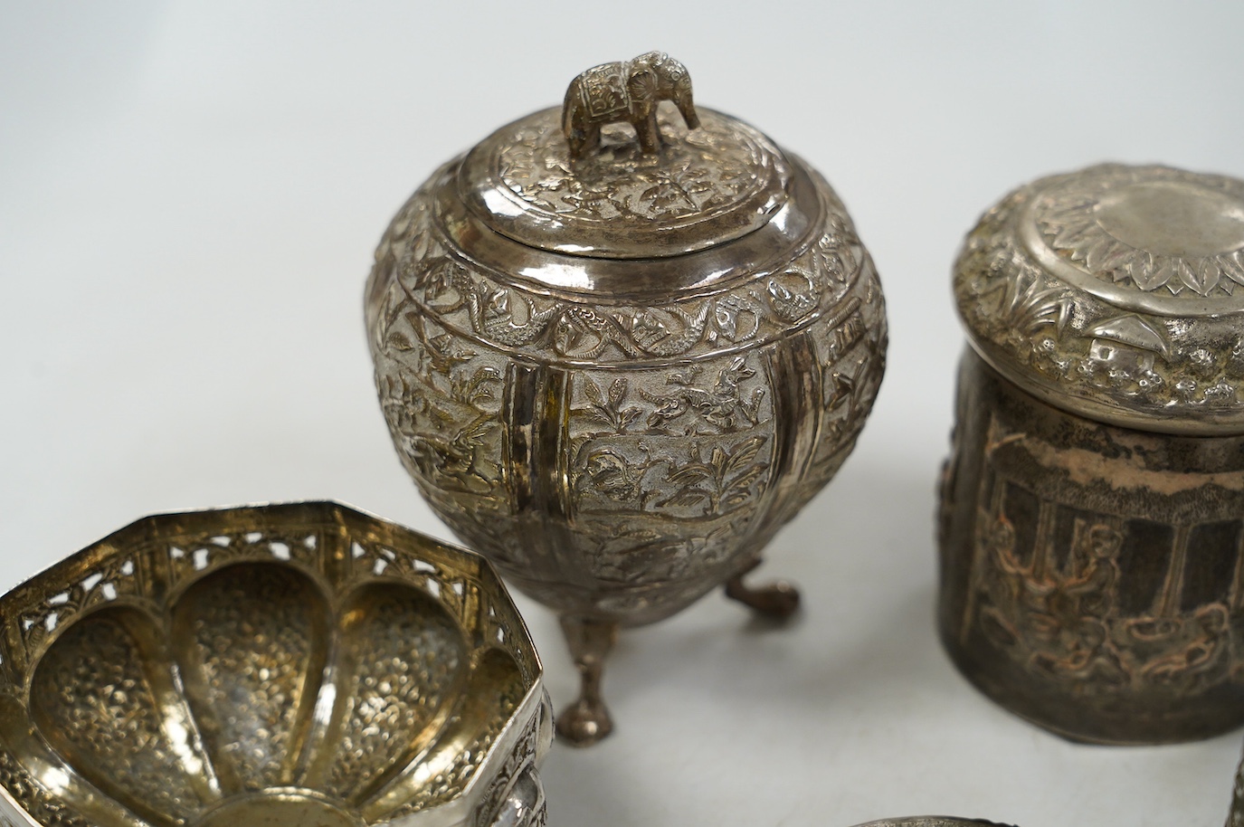 A pair of Indian pierced cusped white metal bowls, diameter 84mm, three other Indian white metal canisters and a Middle Eastern pill box. Condition - fair